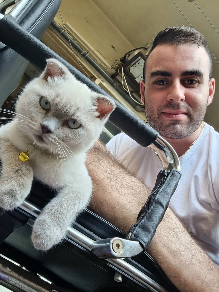 A younger Lotus beside his owner
